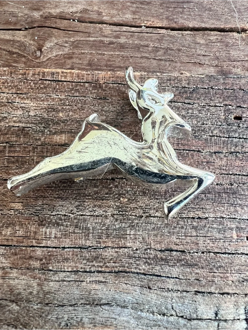 vintage running deer brooch features a stylized, jumping design.  Silver tone